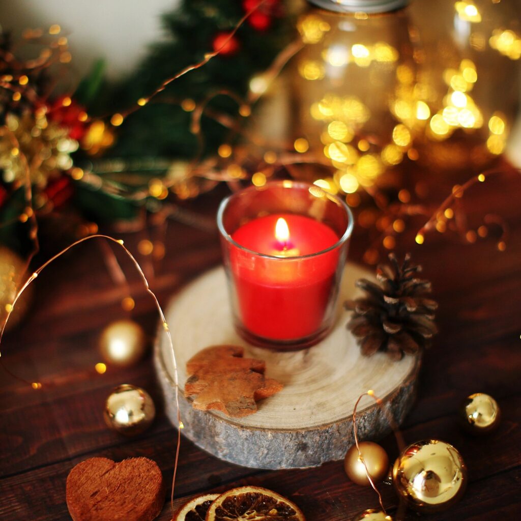 Christmas background candle, mandarins and garland. Preparation for holidays. Top view with copy space.