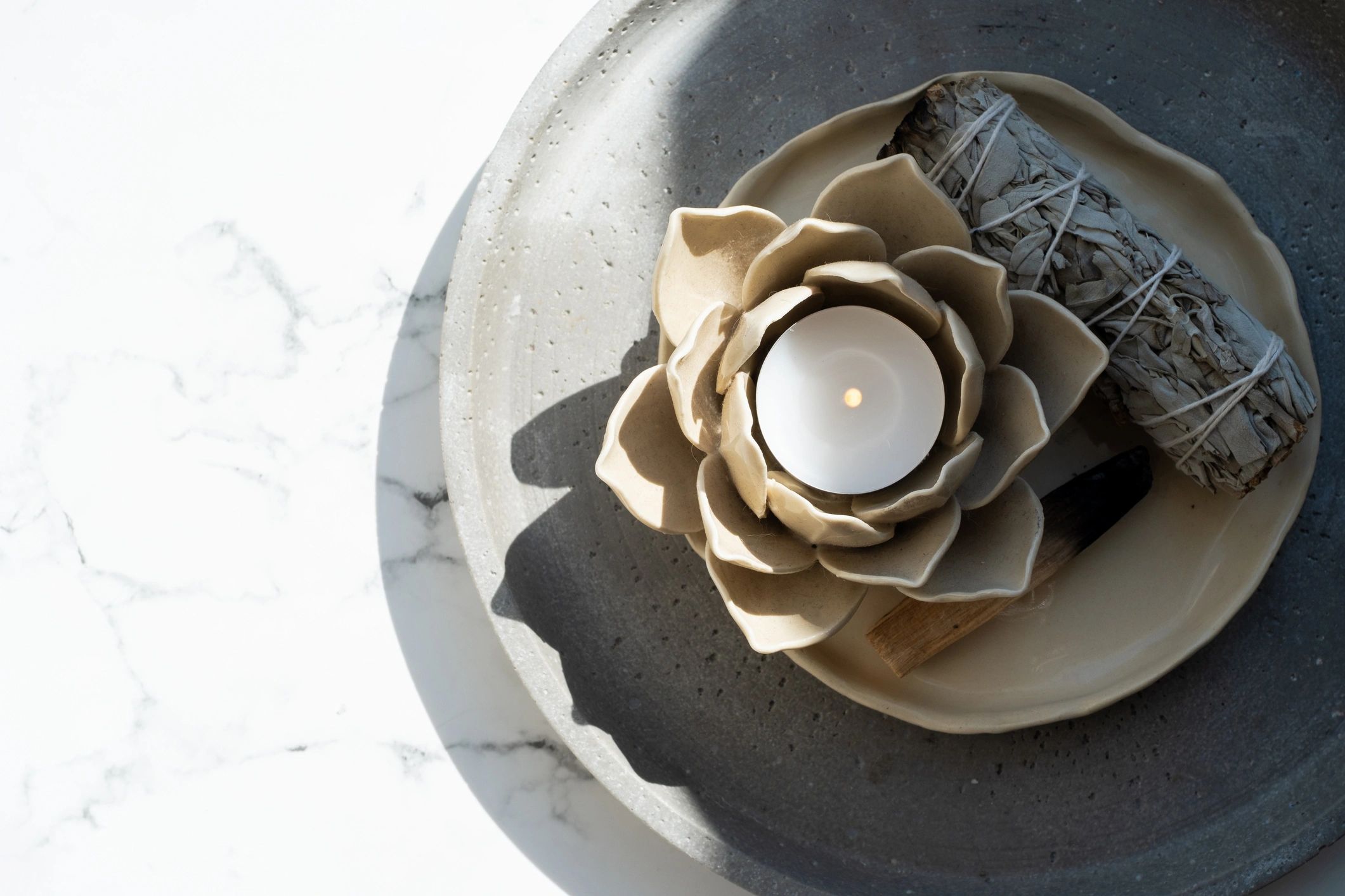 Elegant candle flatlay with soft neutral tones